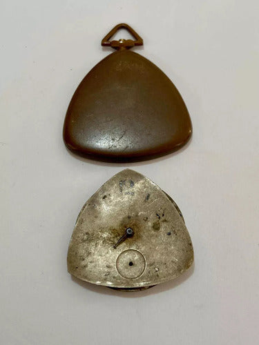 Antique vintage pocket watch machine parts with triangular metal case showing aged and worn surfaces.