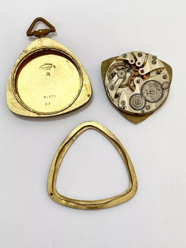 Antique pocket watch parts including gold triangular case, inner mechanical movement, and bezel ring on white background